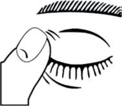 A close-up of a human eye with closed eyelids and long eyelashes, while a finger gently touches the upper eyelid