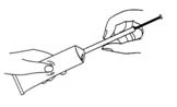 Two hands holding and preparing a long syringe with a thin needle, positioning it at an angle for medication administration