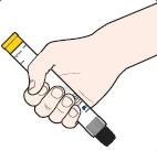 Light-colored hand holding a white pen-shaped injector with a yellow tip and black base, positioned diagonally against a white background