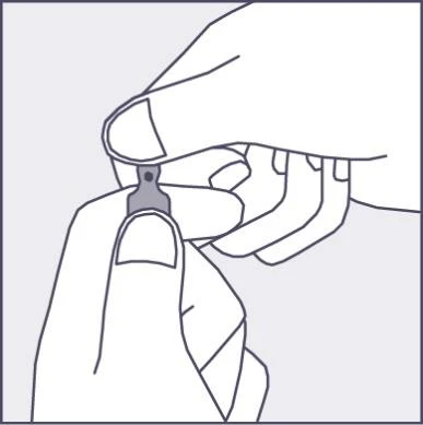 Two hands holding and bending back a small, gray plastic part of a medication package to open or prepare it for use