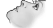 Side profile of a person with a slightly tilted head, with a nasal drug applicator approaching the nose directly