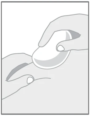 Two hands holding a white, oval tablet or capsule, preparing it for ingestion or splitting into parts