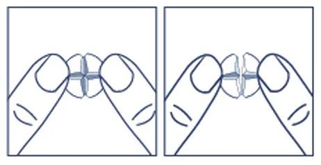 Two hands holding a white tablet being split into two equal parts along a cross-shaped score line