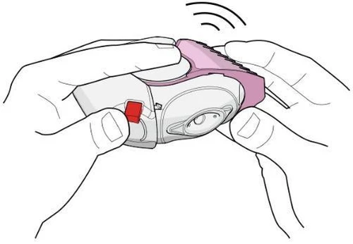 Two hands holding a white-pink auto-injector with a red button, preparing the device for subcutaneous drug administration