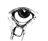 Close-up of the human eye with the index finger gently pulling the lower eyelid downward for medication application