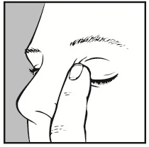 Close-up of the face in profile, with the index finger pressing the point between the eye and nose, just beneath the eyebrow, for medication application