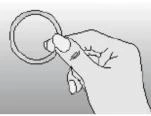 Right hand holding a round, thin ring or disc with fingers against a bright, uniform background in black and white outline