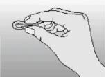 Human hand holding a small, round object resembling a tablet or capsule against a bright, uniform background
