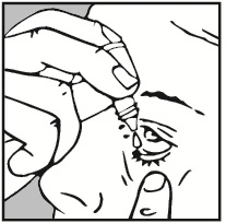 A hand holding a small bottle of eye drops, with one drop entering directly into an open eye showing the eyelid and eyelashes