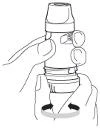 Hand holding a white syringe vertically, while a second hand performs a twisting motion at the base of the device, indicated by black arrows