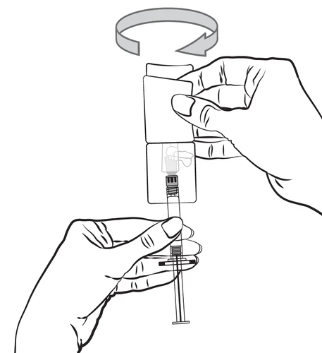 Hands holding a syringe and a dose adjuster; one hand rotates the upper part of the device in the direction indicated by the curved arrow