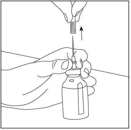 Hand holding a glass vial while the other hand lifts the needle with sheath upward after inserting it through the vial stopper