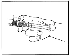 Hand holding a syringe horizontally, showing a visible measuring scale and plunger, preparing to administer a drug dose