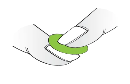 Two hands holding a green, round ring-shaped tablet, preparing it for administration or dosing
