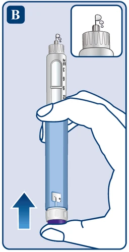 Hand holding vertically a long blue-white injector showing a milliliter scale, with a close-up on the upper part of the device showing a drop of liquid