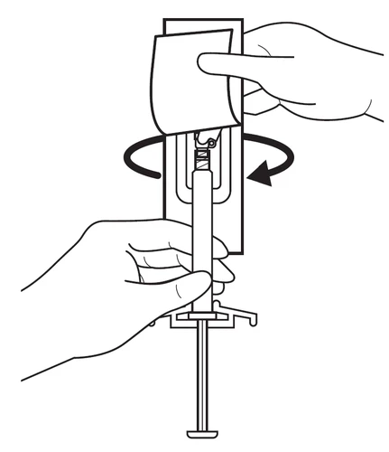 Two hands holding a syringe, one hand removing the protective cap while the other stabilizes the device, with an arrow indicating rotational movement of the component