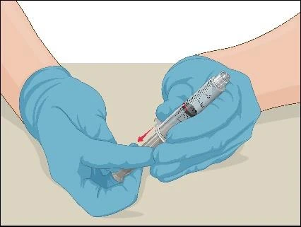 Hand in a blue medical glove holding a syringe with a needle, preparing to administer medication against a light background