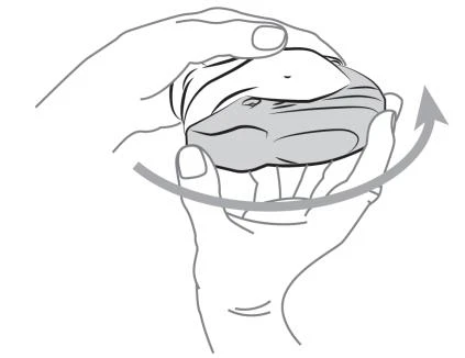 Hands holding a circular object being rotated to the right, indicated by a curved arrow showing the direction of movement