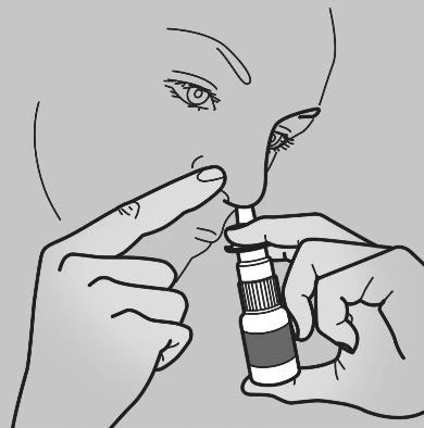Illustration showing a close-up of a person's face holding a small bottle and administering drops directly into the nose using a pipette