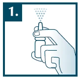 A hand holding a white atomizer pointed upward, emitting a fine mist of sprayed medication in the form of small droplets