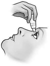A hand holds a small bottle with an applicator, bringing the tip close to the eye of a person looking upward to administer medication drops