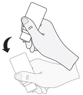 A hand holding a white medication package being turned downward in the direction indicated by a black arrow