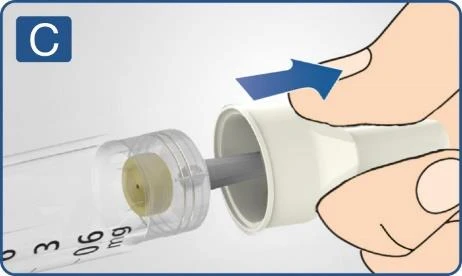 Hand removing a white cap from the tip of a transparent syringe showing a drug dose in milligrams, with a blue arrow indicating direction of movement