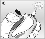 Hand pressing the inhaler button, releasing a puff of medication for oral inhalation