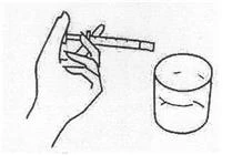 Una mano tiene una siringa mentre la inserisce in una fiala di vetro per aspirare il liquido; accanto è posizionato un contenitore cilindrico pieno di liquido