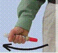 A hand in a green sleeve holds a syringe with a red cap, moving to the left to indicate the direction of drug administration