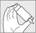Hand holding an inhaler, fingers pressing the button to release a dose of medication for inhalation through the mouth