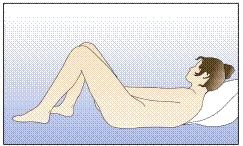 A woman lying on her back on a bed with knees elevated, head resting on a pillow, prepared for a medical procedure