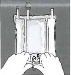 Two hands holding a medical device with two vertical tubes and a central D-shaped component designed for fluid or medication administration
