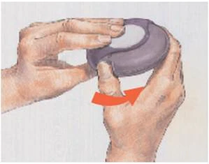 Two hands holding a purple device, one finger pressing down on it, with a red arrow indicating the direction of movement to activate the mechanism