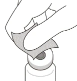 Hand wiping the surface of a medication vial with a wet wipe before use to ensure sterility