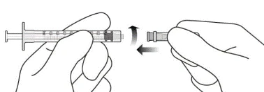 Hands attaching a needle to a syringe by turning it clockwise to secure it