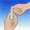 Hand holding an inhaler, the other hand pressing the button to release a dose of medication, blue background